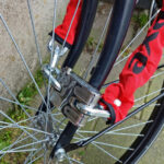 Image of a sturdy bicycle chain and lock around a bike wheel