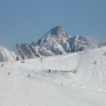 Image of people skiing on steeper mountain slope