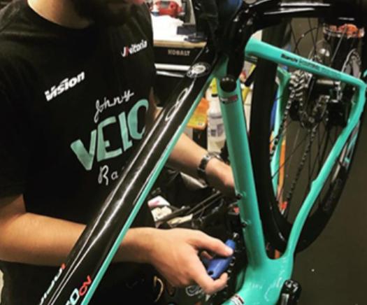 Image of a staff member working on fixing a bicycle 